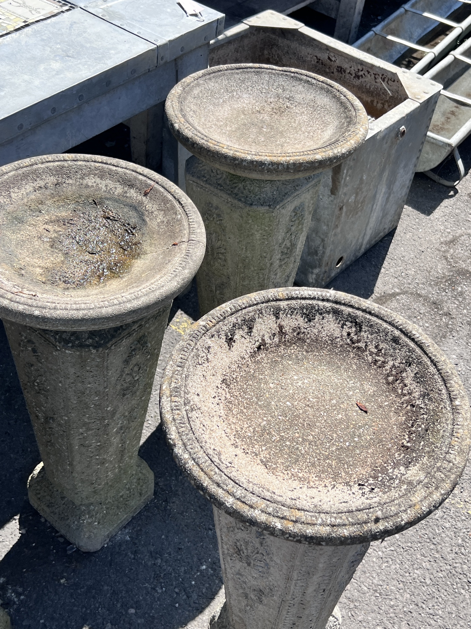 A set of four reconstituted stone circular bird baths, height 74cm